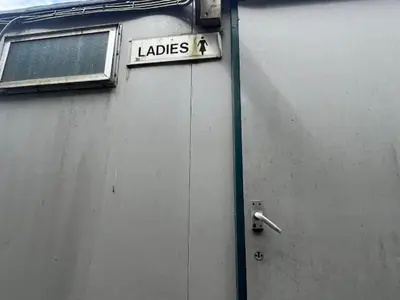 a sign on the side of a building that says ladies at Tick Bridge cabin in Lyonshall