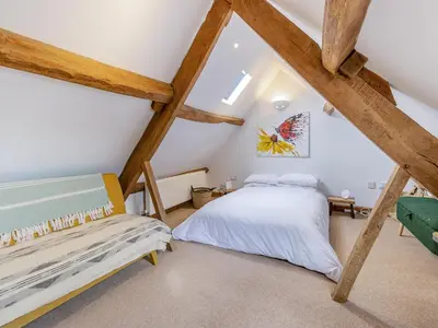 a bedroom with two beds in a attic at Hays Boathouse-Maes-Y-Caer in Hay-on-Wye