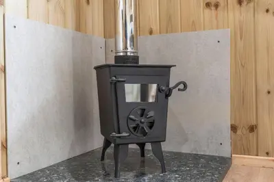 a black stove sitting on top of a counter at Starry Nights Escape - Hot Tub & Sauna in Yarpole