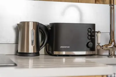 a toaster and coffee pot sitting on a kitchen counter at Starry Nights Escape - Hot Tub & Sauna in Yarpole