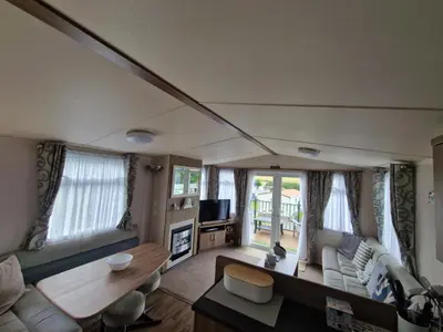 a living room with a couch and a table at Green Heaven at Clarach Bay Spacious 3 BedPet Friendly Luxury Steps from the Sea in Aberystwyth