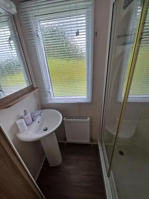 a bathroom with a sink and a shower at Green Heaven at Clarach Bay Spacious 3 BedPet Friendly Luxury Steps from the Sea in Aberystwyth