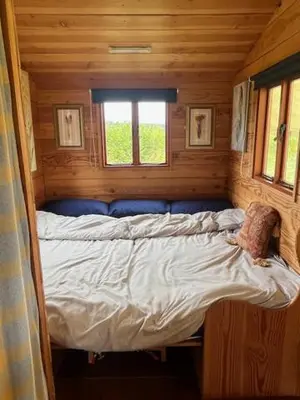 a bed in a small room in a cabin at Tinkers Horn Cabin in Kington