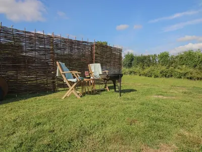 two chairs and a table in the grass at Squirrel's Drey in Bucknell