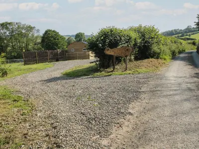 a dirt road with a sign on the side of it at Squirrel's Drey in Bucknell