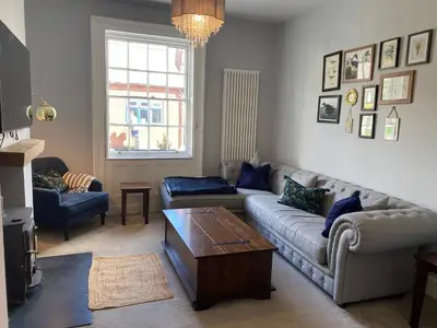a living room with a couch and a coffee table at Town centre Victorian period 3 bedroom home in Bishops Castle