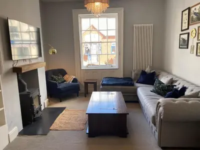 a living room with a couch and a coffee table at Town centre Victorian period 3 bedroom home in Bishops Castle