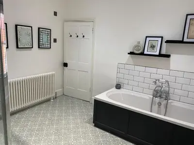 a bathroom with a bath tub in a room at Town centre Victorian period 3 bedroom home in Bishops Castle