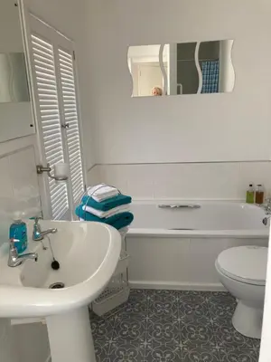 a bathroom with a sink and a tub and a toilet at Ludford View, riverside cottage in Ludlow with private parking in Ludlow