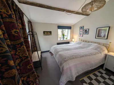 a bedroom with a large bed and a window at Grosvenor Studio Apartment in Llandrindod Wells