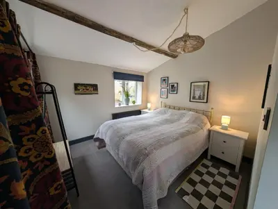 a bedroom with a large bed and a window at Grosvenor Studio Apartment in Llandrindod Wells