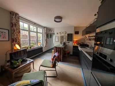 a kitchen and living room with a large window at Grosvenor Studio Apartment in Llandrindod Wells
