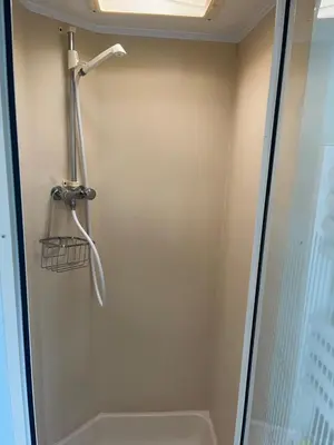 a shower in a bathroom with a glass door at Static Caravan in Aberystwyth