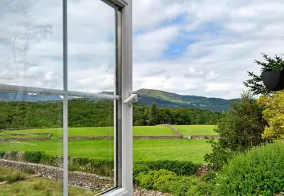 an open window with a view of a green field at Finest Retreats - Penclogwynau in Dolgellau