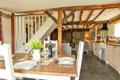 a dining room with a wooden table with chairs at Finest Retreats - Penclogwynau in Dolgellau