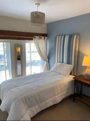 a bedroom with a large bed and a window at Y Bwthyn in Llanfihangel-geneuʼr-glyn