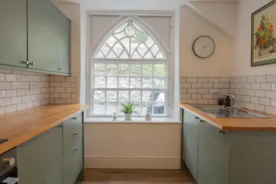 a kitchen with a sink and a window at Charming Eco Hideaway on the Dee River with Private Relaxing Hot Tub in Llangollen