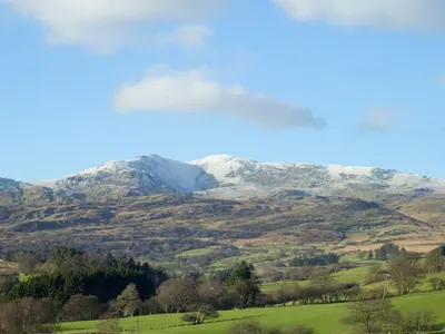 a view of a mountain range with snow covered mountains at Cyffdy Cottage - Aran in Bala
