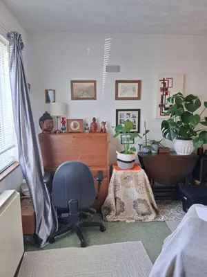 a room with a desk and a chair in it at King bed, opposite the beach in Borth