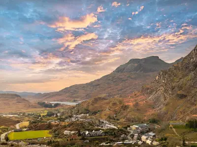 a view of a town in a valley with mountains at Tegfryn Cottage in Tanygrisiau