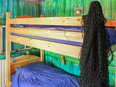 a bedroom with a bunk bed with a long black tail at Farm House - Uk50262 in Llandeilo