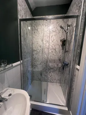 a bathroom with a shower and a toilet and a sink at Cantre Selyf in Brecon
