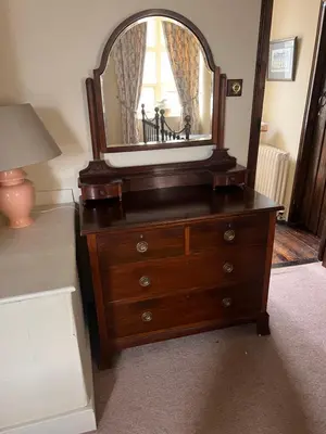 a dresser with a mirror on top of it at Cantre Selyf in Brecon