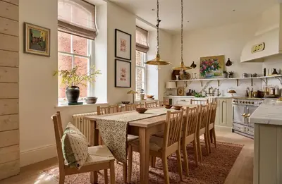 a dining room with a table and chairs in a kitchen at Castle Corner, The Georgian House in Ludlow