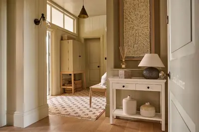 a room with a hallway with a table and a lamp at Castle Corner, The Georgian House in Ludlow