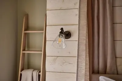 a light hanging from a wall in a room at Castle Corner, The Georgian House in Ludlow