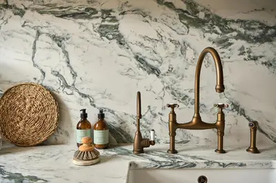 a kitchen counter with a sink and two taps at Market View - The Georgian House in Ludlow