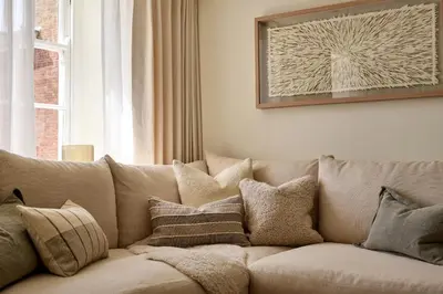 a couch with pillows on it in a living room at Market View - The Georgian House in Ludlow
