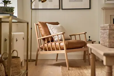 a brown chair with a pillow in a living room at Stretton Hills Peaks - The Georgian House in Ludlow