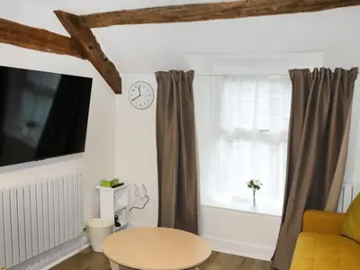 a living room with a table and a window at Apartment Two - Uk49592 in Bala