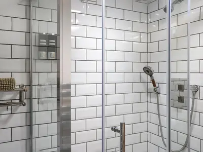 a bathroom with a shower with white tiles at Apartment Two - Uk49592 in Bala