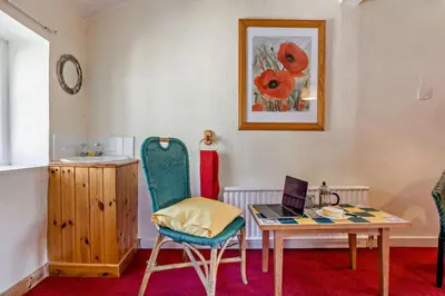 a room with a table with a laptop and a chair at 2 Bed in Brecon oc-t32728 in Brecon