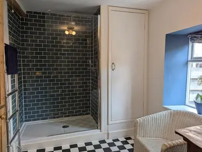 a bathroom with a shower with a bath tub at Compton House, Llanfyllin in Llanfyllin