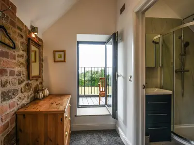 a bathroom with a sink and a shower and a window at Shropshire Way Stay in Farden