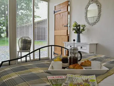 a table with a tray of food on top of it at Caeley Barn in Penybont