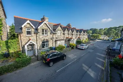 a car parked in front of a row of houses at Bodelen in Llanbedr