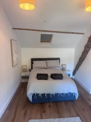 a bedroom with a bed with two pillows on it at 4 Bedroom All En suite Central Townhouse Ideal for Groups in Builth Wells