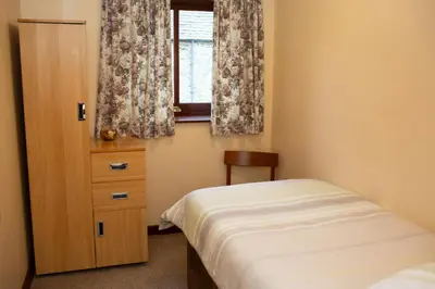 a small bedroom with a bed and a window at The Granary Aberystwyth in Aberystwyth