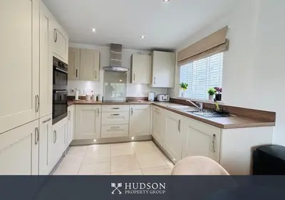 a kitchen with white cabinets and a large window at 3 Bed Stylish Shrewsbury Home in Shrewsbury