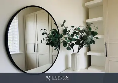 a mirror in a room with a vase with a plant at 3 Bed Stylish Shrewsbury Home in Shrewsbury