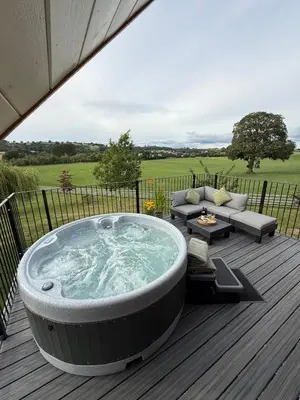 a jacuzzi tub on a wooden deck at Minafon Loft in Meifod