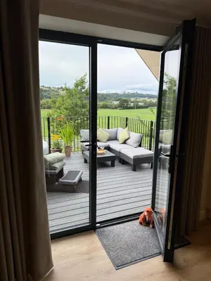 a living room with a couch and a patio at Minafon Loft in Meifod