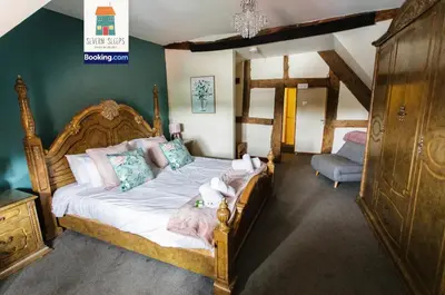 a bedroom with a bed with white sheets and pillows at Spacious 5 Family Rooms House By Shropshire Escapes Short Lets & Serviced Accommodation Shrewsbury With Free WiFi in Shrewsbury