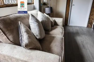 a couch with pillows on it in a living room at Spacious 5 Family Rooms House By Shropshire Escapes Short Lets & Serviced Accommodation Shrewsbury With Free WiFi in Shrewsbury