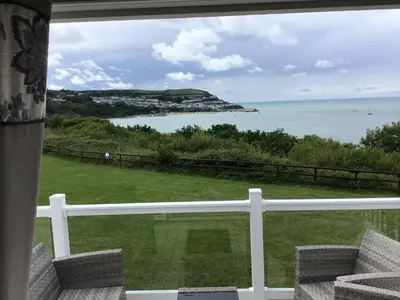 a view of the ocean from a house balcony at Lodge - Sleeps 4 Near beach & Free parking in Llanina