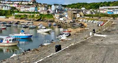 a group of boats are docked in a harbor at Lodge - Sleeps 4 Near beach & Free parking in Llanina